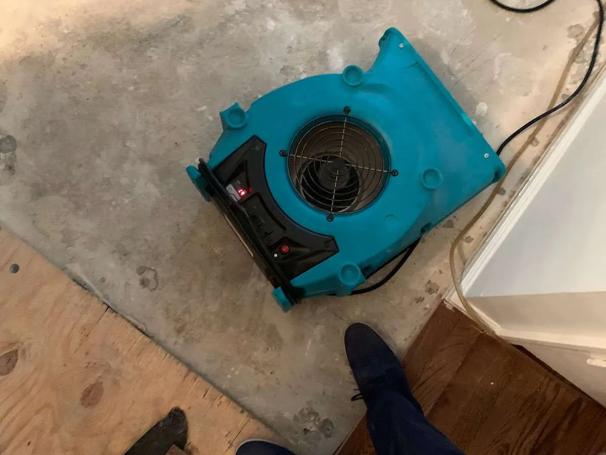 Air mover drying subfloor during Commercial Water Damage Restoration in Ohio
